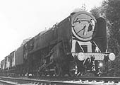 British Railways Standard class 9F 2-10-0 No 92067, of 2D shed, is seen heading a freight train with a special load of  three brake vans