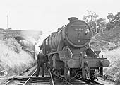 The fireman of ex-LMS 8F 2-8-0 No 48386 prepares to pass the staff to Frank Prew as it exits the single line
