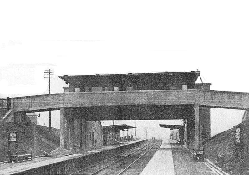 Looking along Lea Hall's up platform towards Birmingham with the main Booking Office suspended above the line