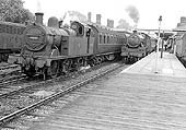 Ex-LMS 2P 04-4T No 41902 arrives at platform one at the rear of a two-coach motor fitted train to Rugby whilst an unidentified ex-LMS Stanier 2-6-4T stands in platform two