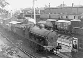Ex-LNWR G class 0-8-0 No 1540 passes through Leamington Avenue station on a down goods train with a GE ventilated van behind the tender on 26th May 1925