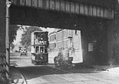 Close up showing a Coventry tram proceeding under Longford Bridge towards the city centre