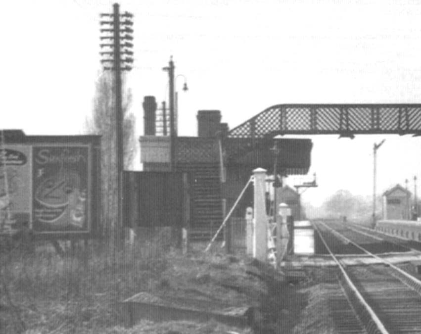Close up looking towards New Street showing Marston Green station from the Coventry side of the level crossing