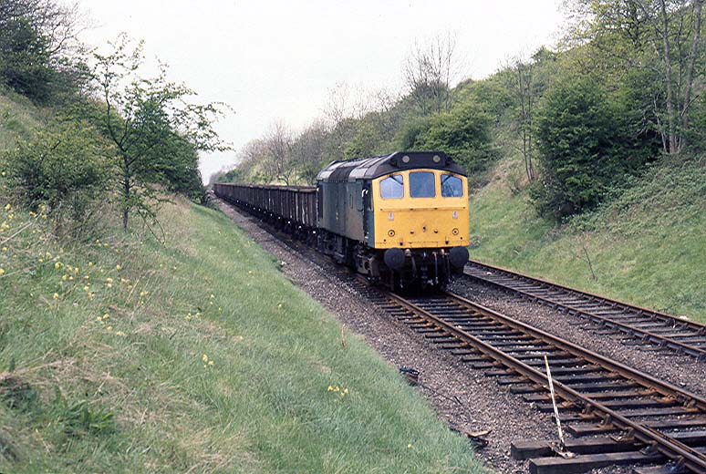 One of four photos showing D25 265 at the head of wagons being delivered and returned from Southam Cement Works in March 1982