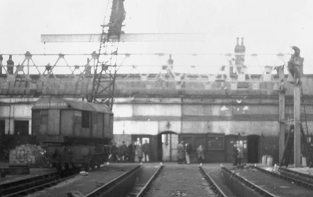 View of Monument Lane's crane using a spreader beam to remove one of the shed's roof trusses