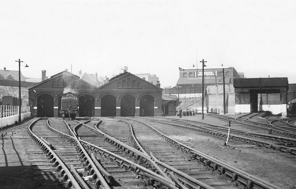 View of a clean Monument Lane shed showing an unidentified solitary ex-LNWR 0-6-2T locomotive