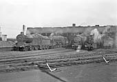 A number of ex-LMS locomotives are seen being prepared in front of the shed ready for their next rostered trips