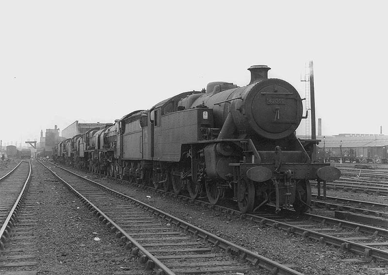 Ex-LMS design 2-6-4T 4MT No 42069 is seen standing at the head of a line of withdrawn passenger and goods locomotives at Nuneaton shed