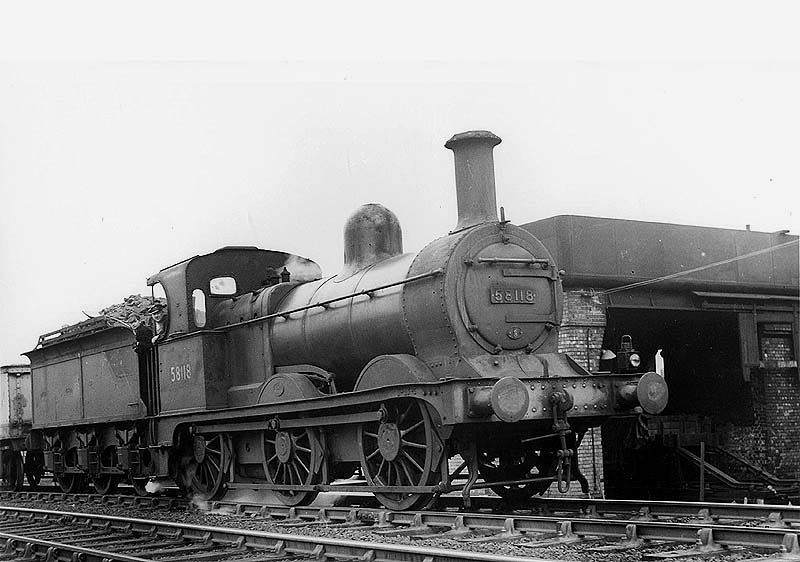 Ex-Midland Railway 0-6-0 2F No 58118 is seen standing alongside the redundant LNWR coaling stage with a train of ash wagons