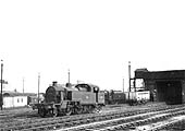 View of ex-LMS 2-6-2T 3MT No 40010 standing in front of the old LNWR Coaling stage with only the overhead water tank still in use