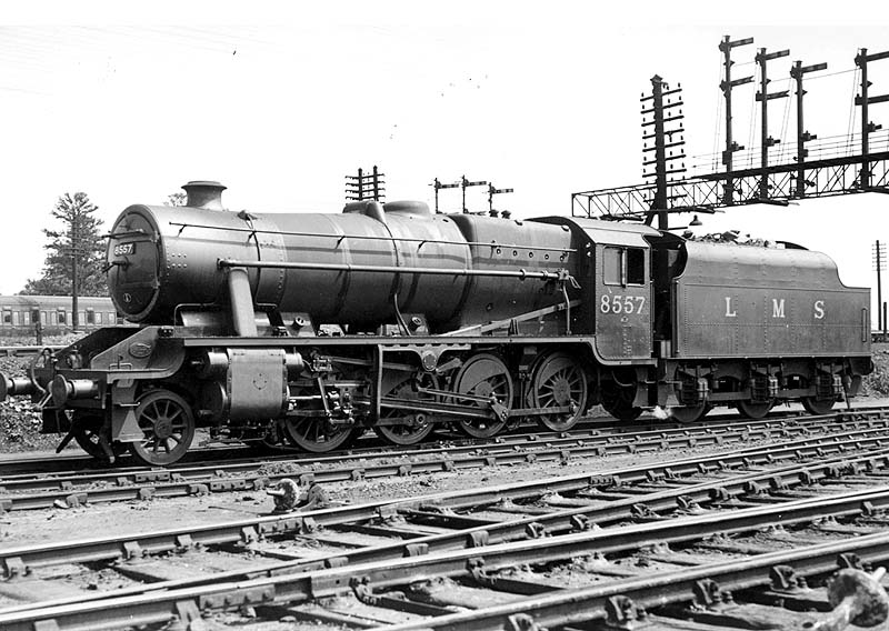 LMS 2-8-0 8F No 8557 stands on shed alongside the main running line with the signals controlling access to the southern approaches to Nuneaton station seen behind