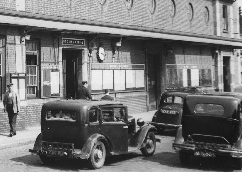 Close up showing the external entrance to Nuneaton Station's Booking Office and timetables on the posterboards