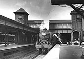 An unidentified ex-LMS 4-6-0 Rebuilt Royal Scot is seen standing at platform four ready to depart for Euston with an up express
