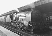 LMS 4-6-2 'Turbomotive' No 6202 is seen passing through Nuneaton station's platform three on a down express service