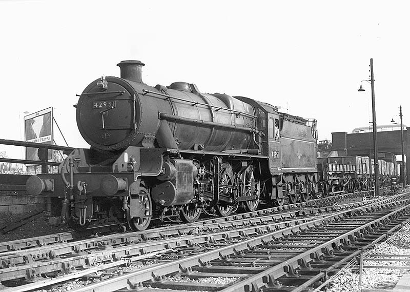 Ex-LMS 2-6-0 No 42951 is seen at the head of a class F express unfitted stock freight working as it enters the up marshalling yard from the south
