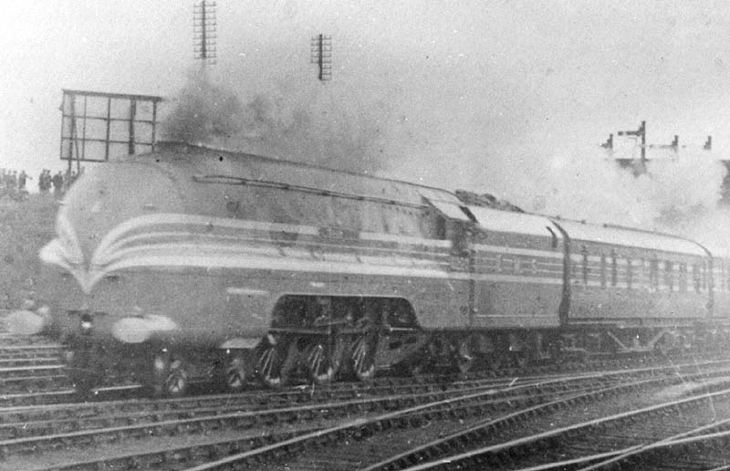 LMS 4-6-2 Coronation class No 6220 'Coronation' is seen passing through Nuneation station at the head of the inaugral down 'Coronation Scot' express