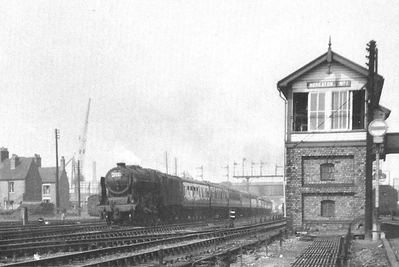 Ex-LMS 4-6-0 rebuilt Jubilee class No 45735 'Comet' is seen at the head of an up express as it passes Nuneaton No 1 Signal Box