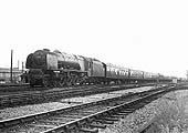 Ex-LMS 4-6-2 Coronation class No 46244 'King George VI' is seen at the head of a long express train passing Nuneaton