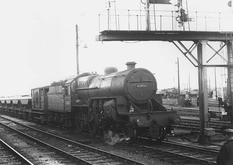 Ex-LMS 2-6-0 Hughes Crab No 42853 is seen at the head of a ballast train waiting for the signal to give it the road from the up marshalling yard