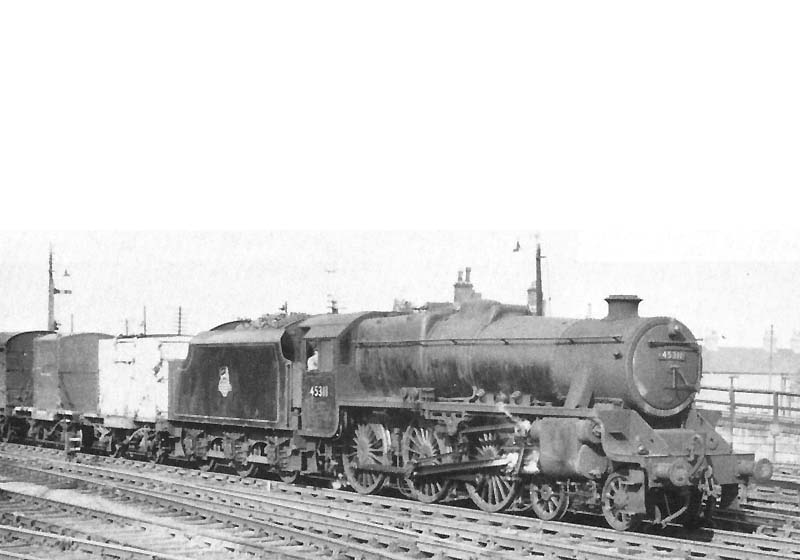 Ex-LMS 4-6-0 'Black 5' No 45311 is seen at the head of a fast fitted freight service as it passes in front of Nuneaton's shunting hump