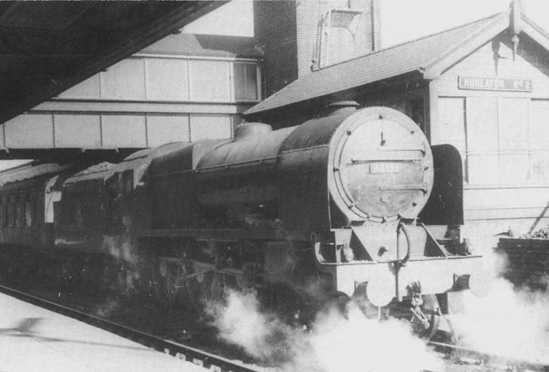 Ex-LMS 4-6-0 Royal Scot class No 46151 'The Royal Horse Guardsman' is seen standing at platform 3 adjacent to Nuneaton No 2 Signal Box