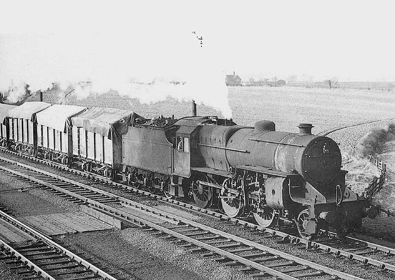 Ex-LMS 2-6-0 Hughes Crab No 42931 seen heading a rake of covered wagons as it passes Ashby Junction during May 1956