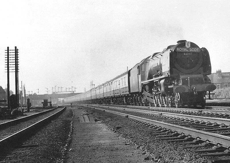 Ex-LMS 4-6-2 Coronation class No 46227 'Duchess of Devenshire' is seen at the head of the up Royal Scot express service as it passes opposite Nuneaton shed