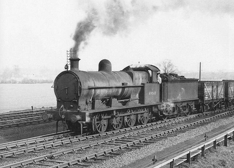 Ex-LNWR 0-8-0 G2a class No 49068 is seen working a train of down empty mineral wagons back to the local collieries as it passes Ashby Junction