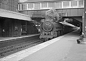 British Railways 4-6-2 Class 7MT No 70048 'The Territorial Army' is seen passing through the station on an up express service