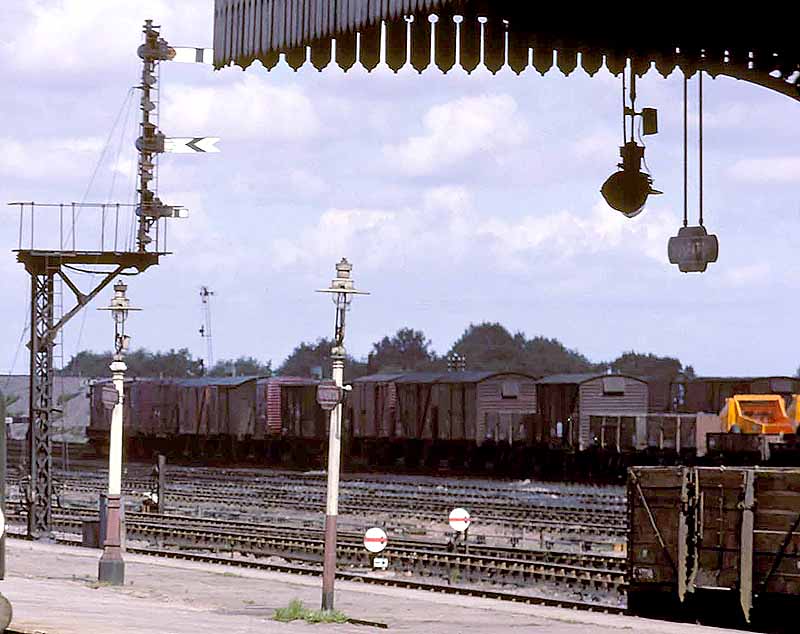 Close up showing some of the rail vans and wagons, painted in bauxite brown, stabled on Nuneaton's up sidings