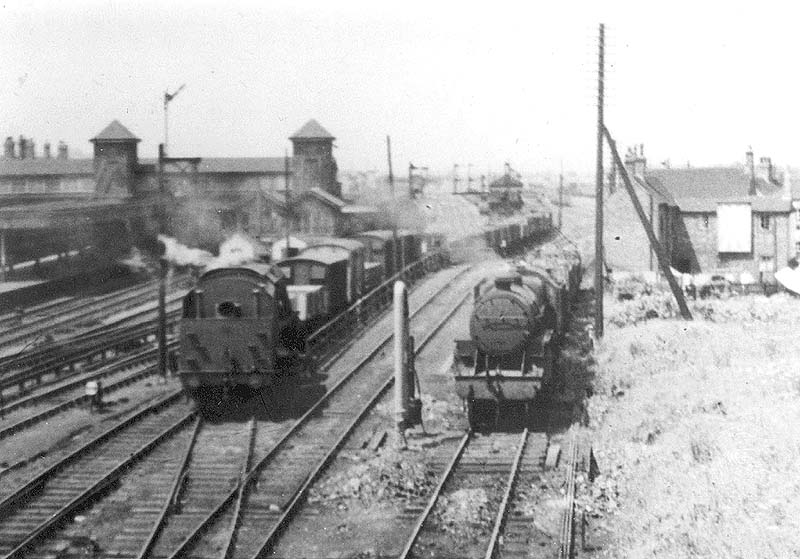 View of the hump and lines to the 'East' goods yard as an unidentified ex-LMS 2-8-0 8F and 2-6-0 6F5P 'Crab' work the yard