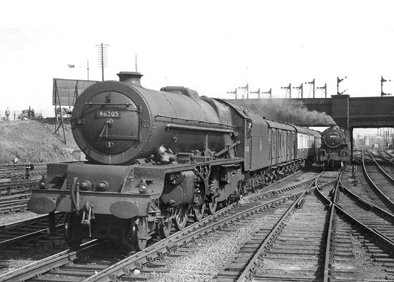 Ex-LMS 8P 4-6-2 Princess Royal class No 46205 'Princess Victoria' is seen at the head of a down express approaching platform three