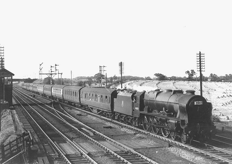 Ex-LMS 4-6-0 7P Rebuilt Royal Scot class No 46124 'London Scottish Regiment' is seen passing Ashby Junction with an up express service