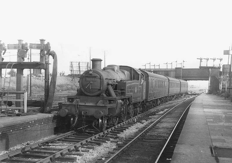 Ex-LMS 3MT 2-6-2T No 40207 is seen arriving at platform two on a three-coach local stopping train from Coventry