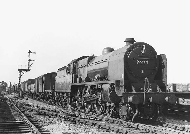 Ex-LMS 4-6-0 Patriot class No 45537 'Private E Sykes VC' is seen passing Nuneaton's marshalling yard at the head of a down through freight train