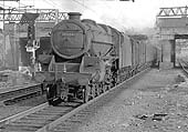 Ex-LMS 4-6-0 5MT No 45134 enters the station at the head of a fully fitted down express freight train