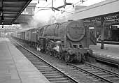  BR 7MT 4-6-2 No 70044 'Earl Haig' heads a down Type 3 Freight service through the station on 13th August 1964