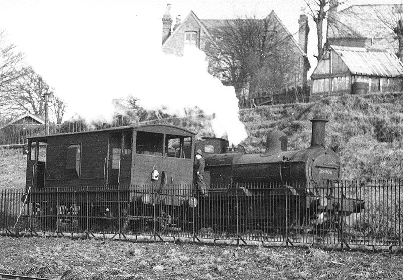 Close up showing ex-Midland Railway Class 2F 0-6-0 No 23006 standing along side an LMS guards van in 1949