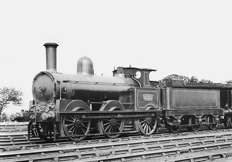 LNWR 0-6-0 'Super DX' No 3121, resplendent in its lined black livery, stands in line at the shed