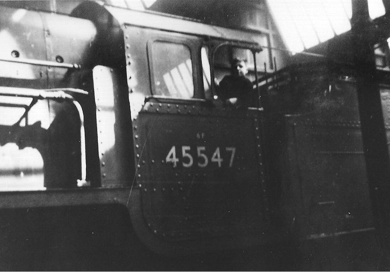 Ex-LMS 4-6-0 'Patriot Class' No 45547 is seen being cabbed by an unknown cleaner within Rugby No 2 shed