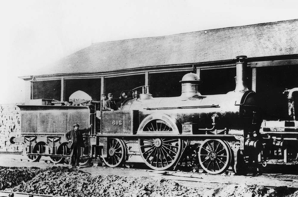 LNWR Southern Division 2-2-2 'Small Bloomer' No 602 seen posed outside one of Rugby's coke sheds circa 1868