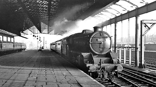 Ex-LMS 5MT 4-6-0 No 44866 is seen arriving at the down platform whilst at the head of a down stopping train