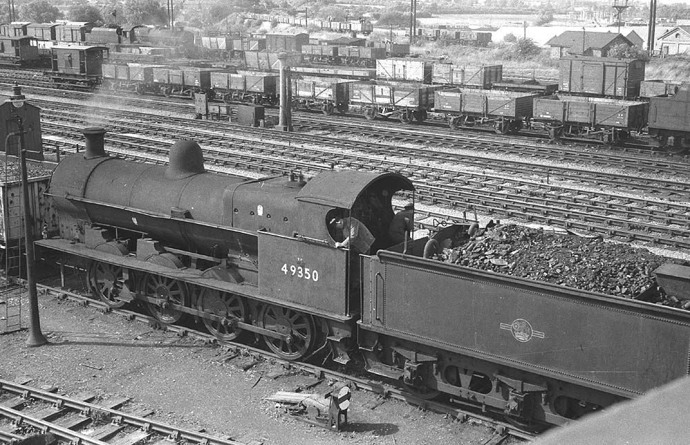 Ex-LNWR 0-8-0 G2a No 49350 is seen on 8th August 1961 shunting in the down yard beneath the footbridge which carried Black Path over the railway