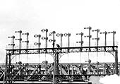 Close up showing two workmen on the top set of signals beneath the signals controlling the lines from Northampton
