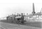 LNWR 2-4-0 No 1217 'Florence' passes through Rugby with an up express with the MR shed in the background
