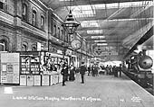 A 1915 view of Rugby station's down platform as a LNWR train for Euston arrives opposite the newsstand