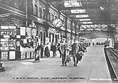 A September 1915 view of Rugby station's down platform as a LNWR train from Euston arrives in the station