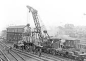 Rugby's brakedown train is seen rerailing mineral wagons alongside Rugby No 5 signal box with the goods yard in the distance