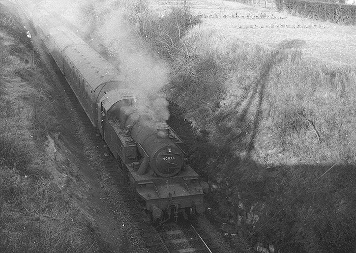 Ex-LMS 3MT 2-6-2T No 40076 is seen at the head of a four-coach Warwick (Milverton) to Weeden local passenger service approaching the station