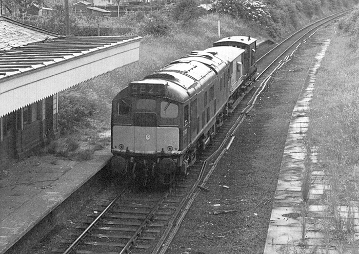 A later view of British Railways Type 2 Bo-Bo D5137 as it propels the two brake vans forward through the closed Southam & Long Itchington station